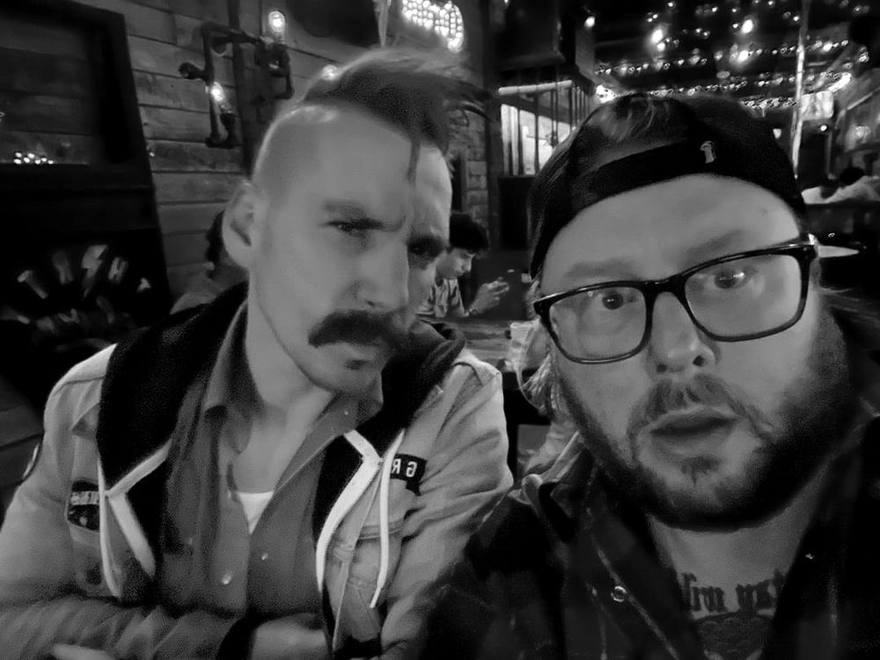 The two hosts in a bar